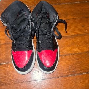 Black and red shiny Jordan ones
